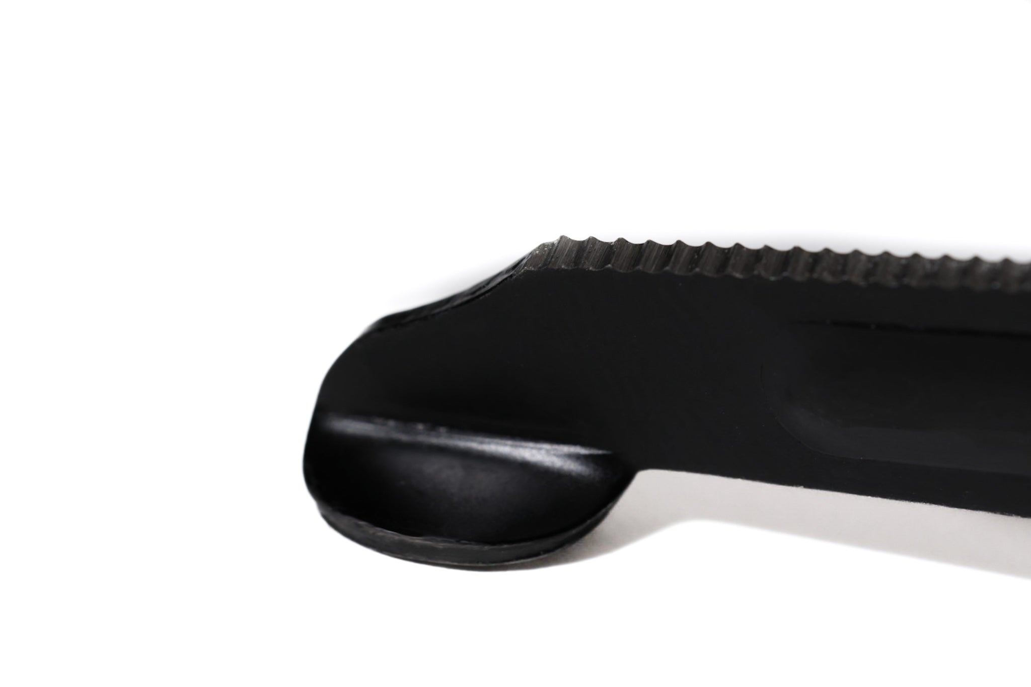 Close-up of the tip of black shears on a white background