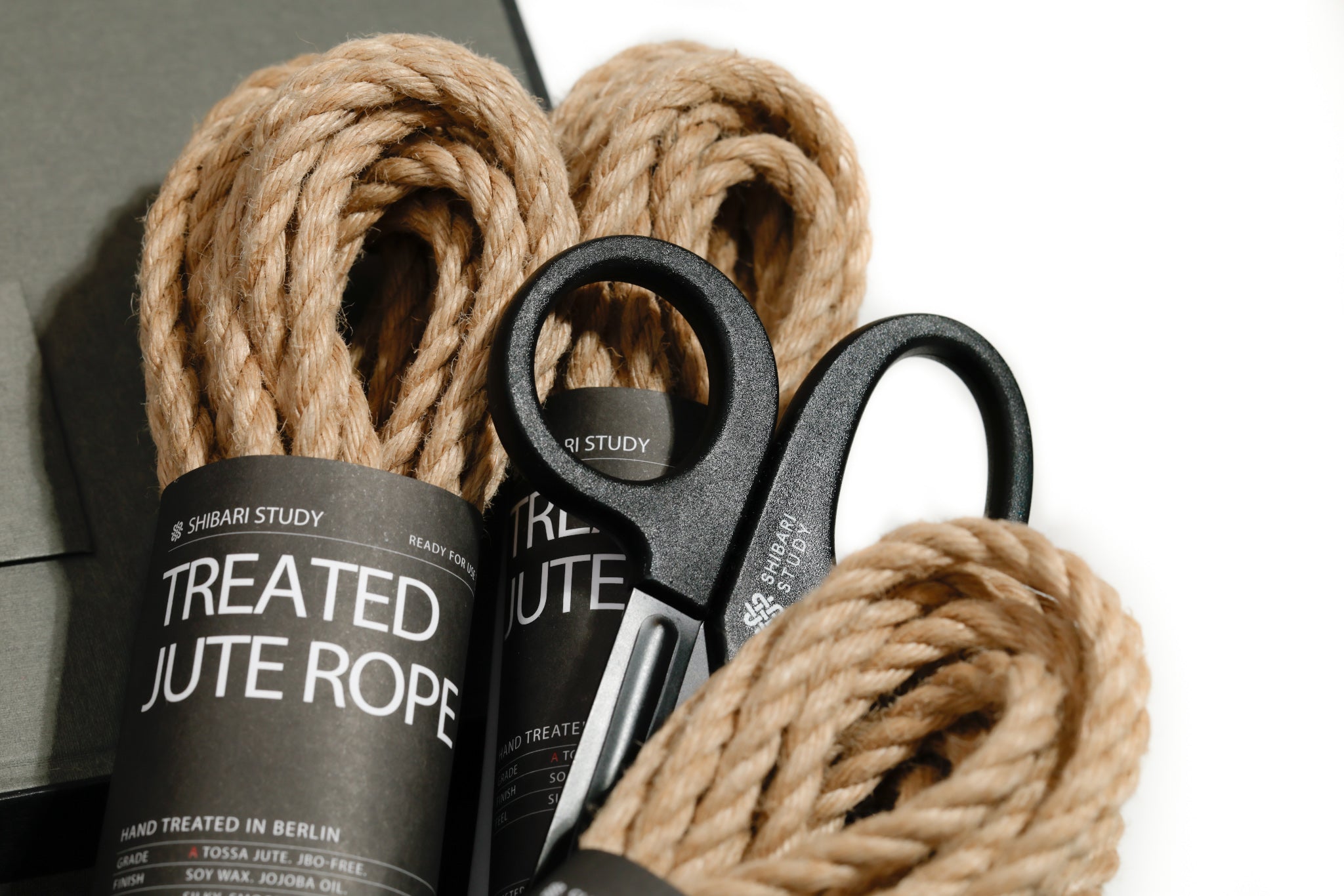 Treated jute rope with scissors on a white background