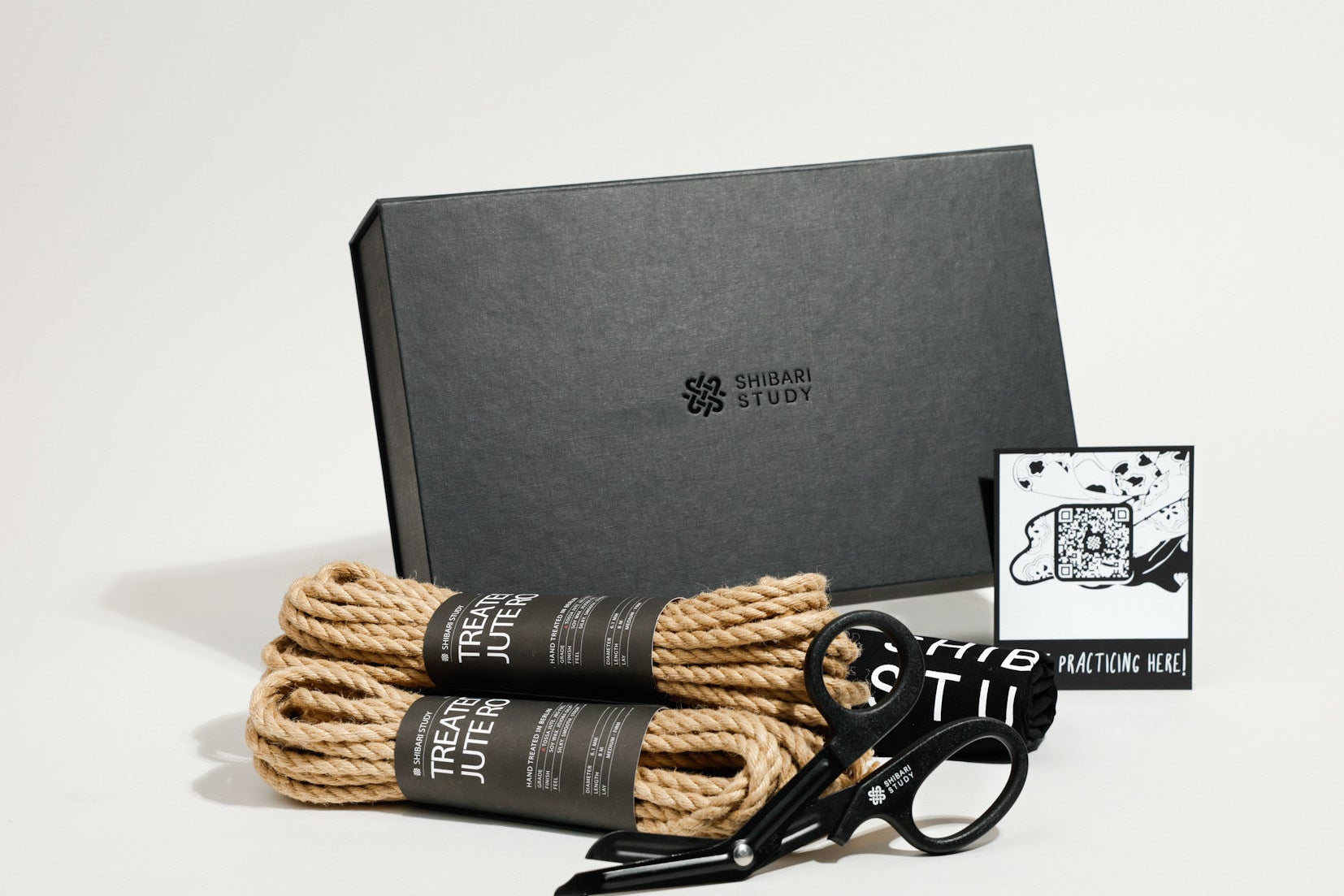 Set of rope, shears, and a card on a gray background with 'Shibari Study' branding.