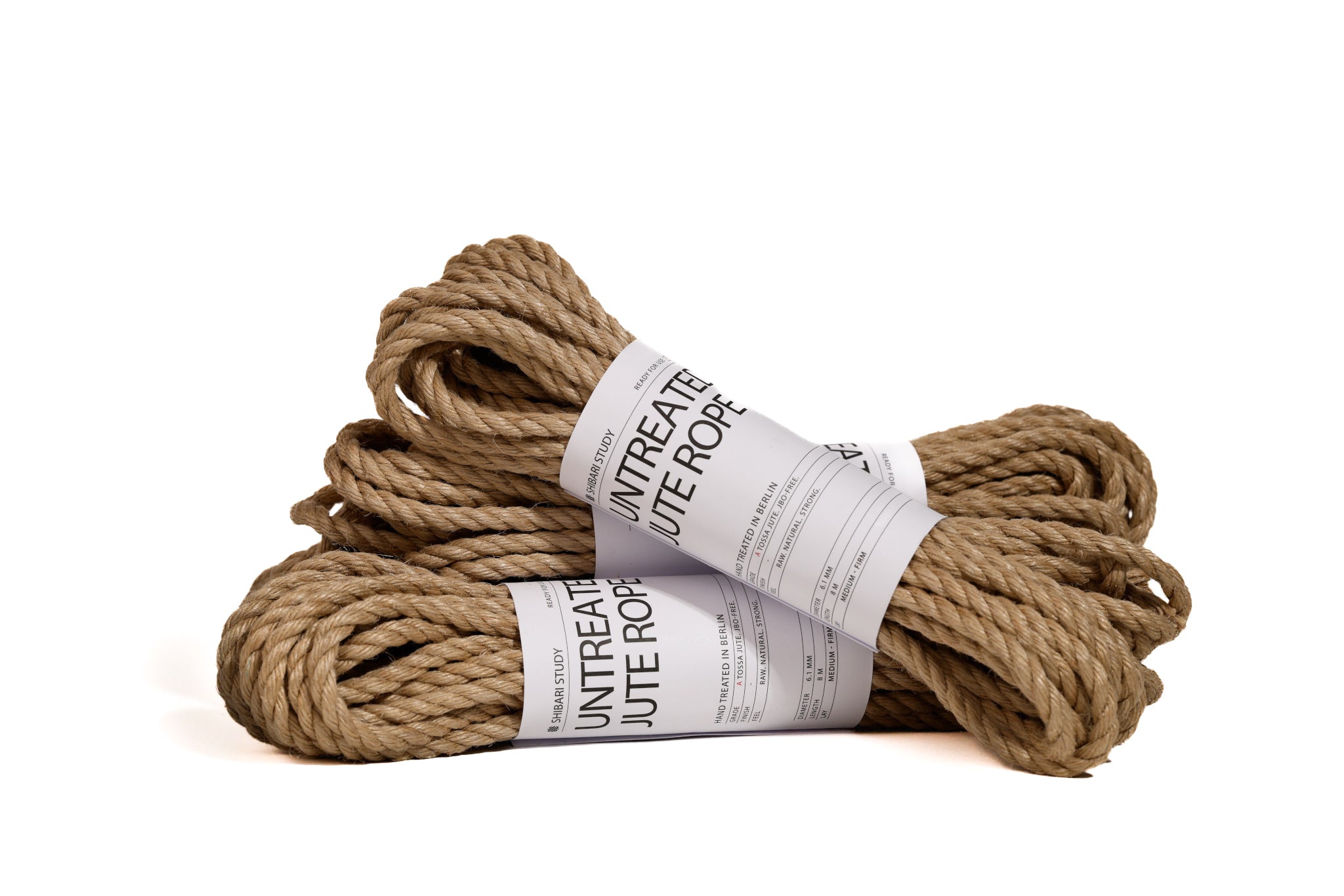 Two bundles of untreated jute rope with labels on a white background