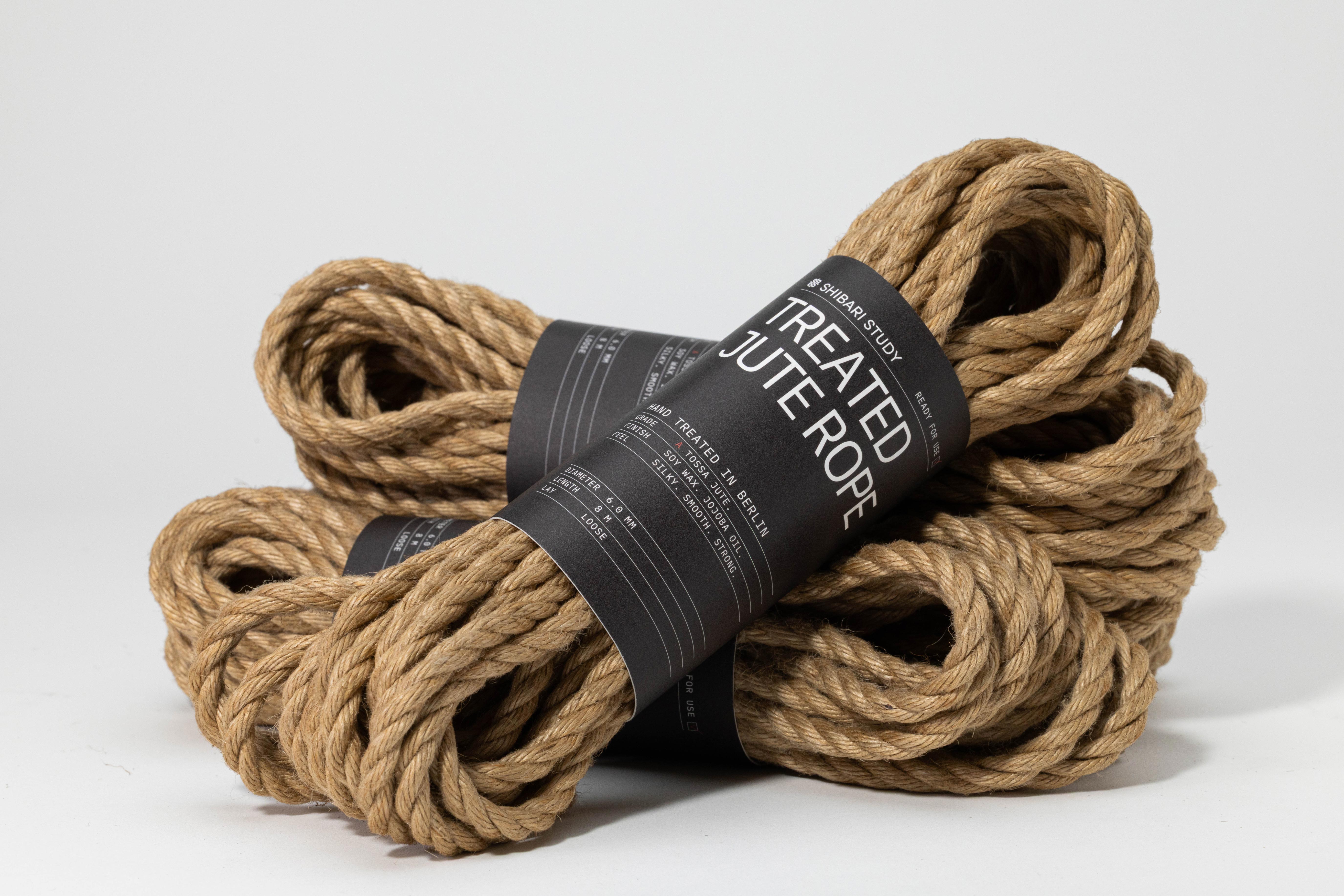 Three bundles of treated jute rope with a label on a white background