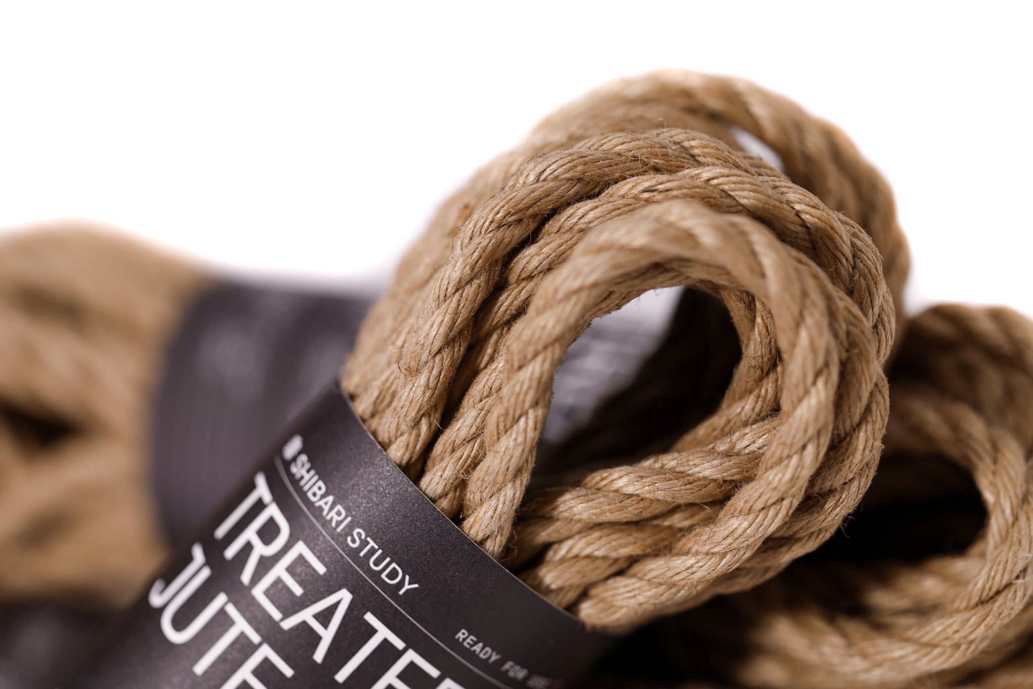 Treated jute rope with a label on a white background