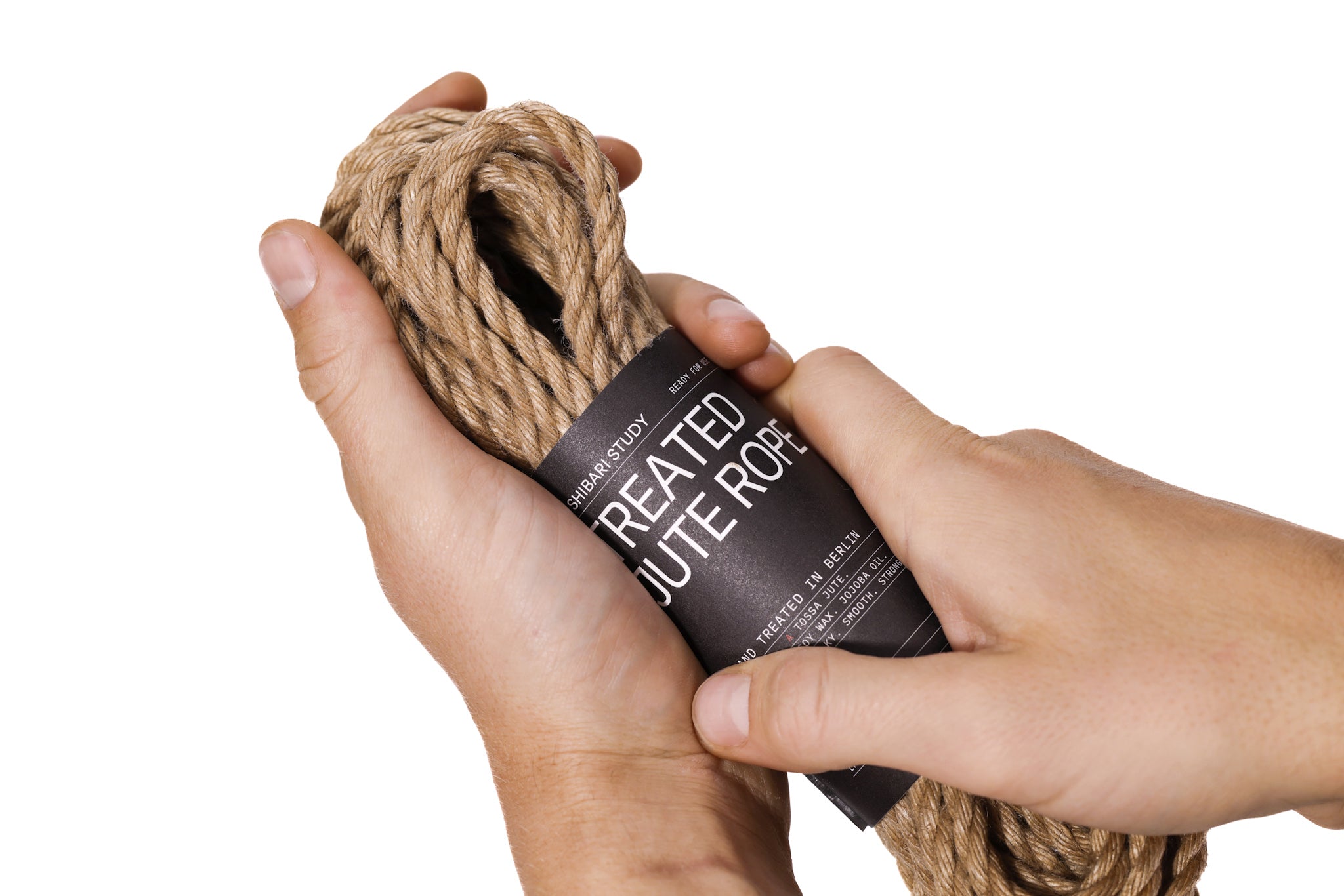 Hand holding a package of Treated Jute Rope against a white background