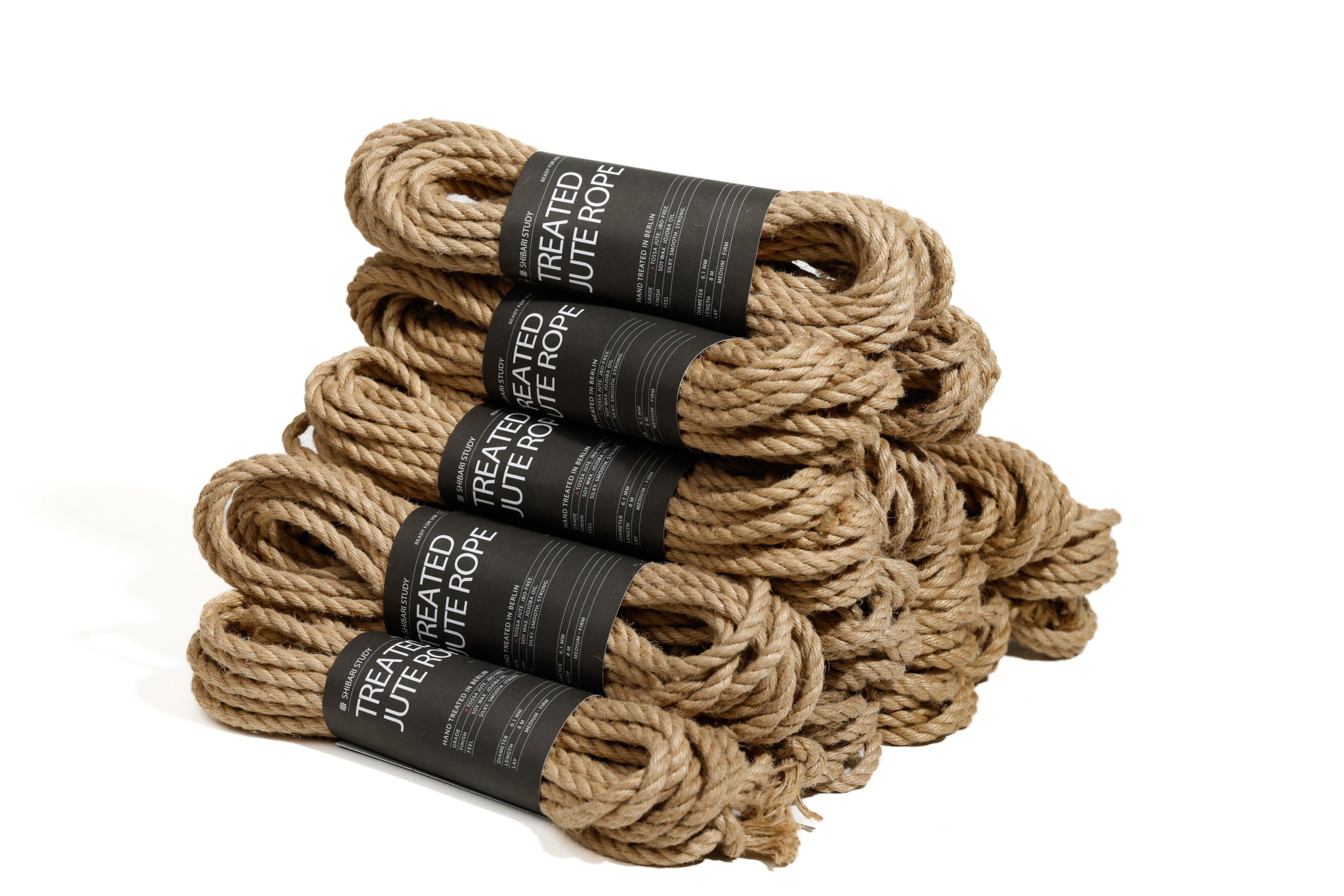 Stack of treated jute rope with labels on a white background